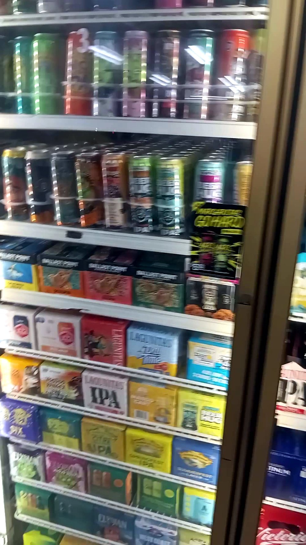 The beer cabinets at E.B. Jr Market — Ballast Point, Lagunitas and San Diego craft IPAs